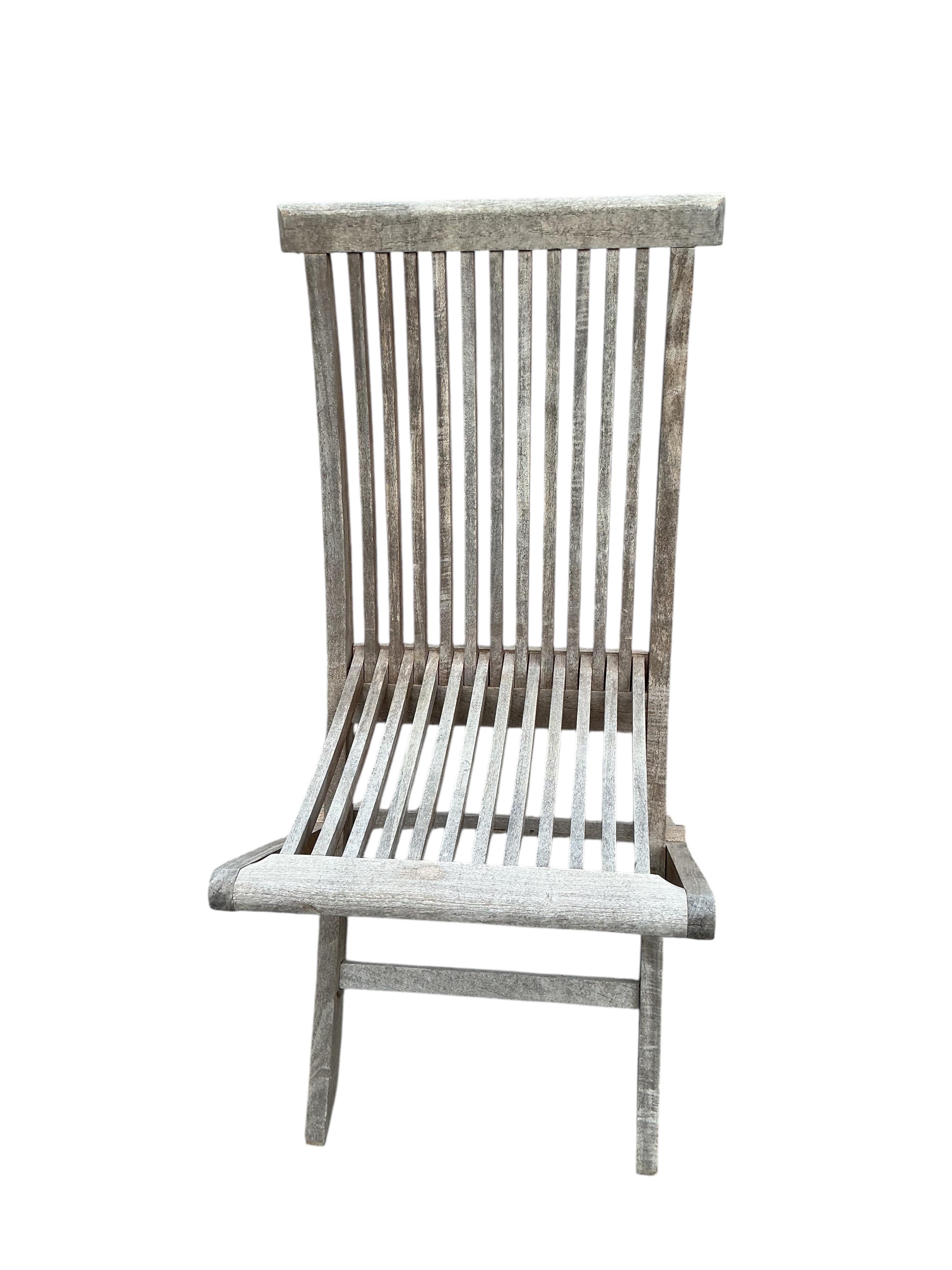 Twelve teak folding garden chairs